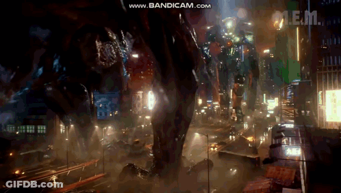 A Giant Robot Is Standing In The Middle Of A City At Night With The Words Www.bandicam.com In The Upper Right Corner GIF