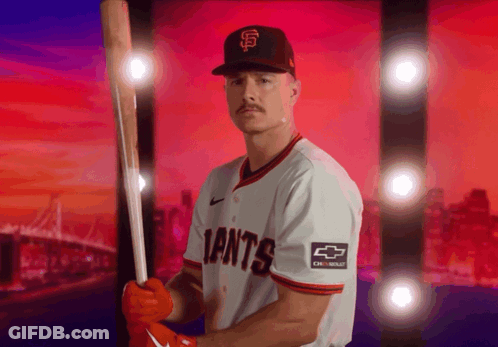 A Giants Baseball Player Is Holding A Bat GIF