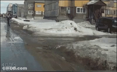 A Gif From 4Gifs.com Shows A Man Walking On A Snowy Street GIF