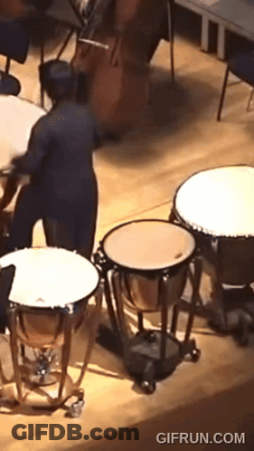 A Gif From Gifrun.com Shows A Man Playing A Drum Set GIF