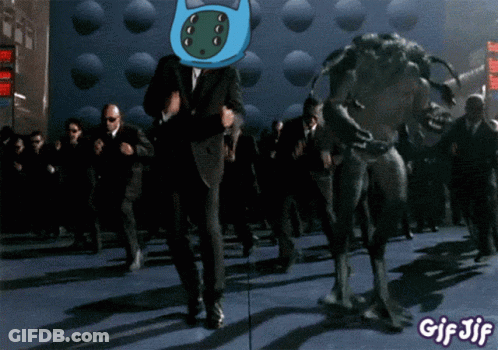 A Gif Of A Man In A Suit Dancing With A Monster And The Words Gif Jif At The Bottom GIF