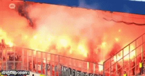 A Gif Of A Stadium With Flames Coming Out Of The Stands Is Being Displayed On Imgflip.com GIF