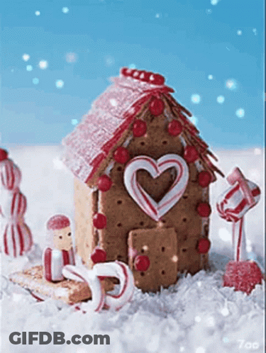 A Gingerbread House Decorated With Candy Canes And A Heart Shaped Door GIF