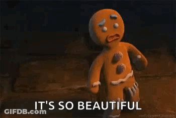 A Gingerbread Man From Shrek Is Standing In A Dark Room . GIF