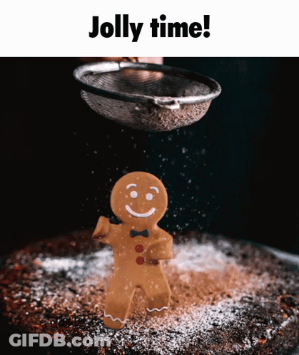 A Gingerbread Man Is Being Sprinkled With Powdered Sugar On A Cake GIF
