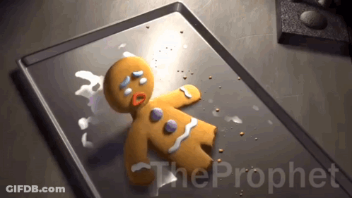 A Gingerbread Man Is Laying On A Baking Sheet With The Prophet Written On The Bottom GIF