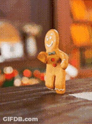 A Gingerbread Man Is Running Down A Street GIF