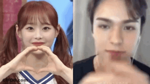 A Girl And A Boy Are Making A Heart With Their Hands . GIF