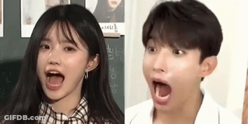 A Girl And A Boy Are Making Funny Faces With Their Mouths Wide Open . GIF