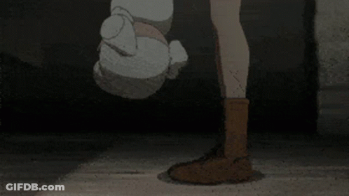 A Girl And A Boy Are Standing Next To Each Other In Front Of A Brick Building . GIF