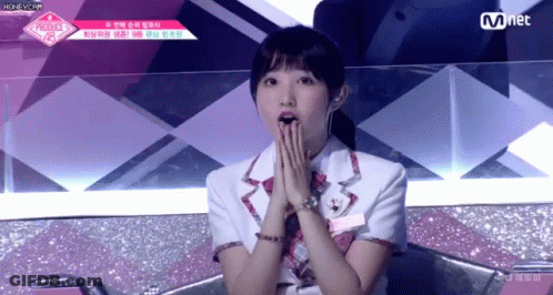 A Girl Covering Her Mouth With Her Hands While Sitting On A Chair . GIF