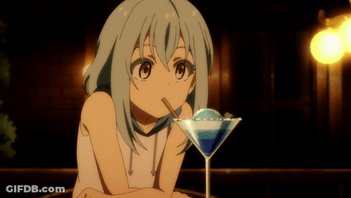 A Girl Drinking From A Martini Glass With A Blue Liquid In It GIF