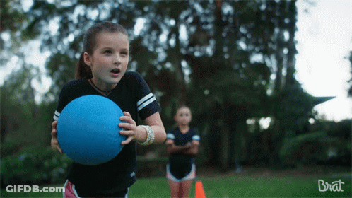 A Girl Holding A Blue Ball In Front Of A Brat Ad GIF