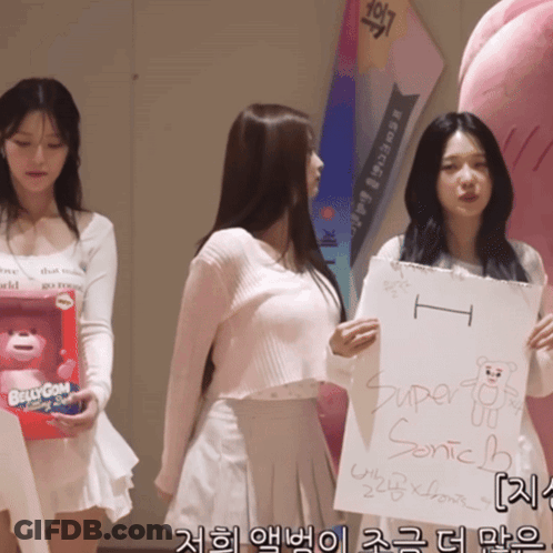 A Girl Holding A Sign That Says Super Sonic Bear GIF