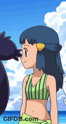 A Girl In A Bikini Is Standing On A Beach With Another Girl GIF