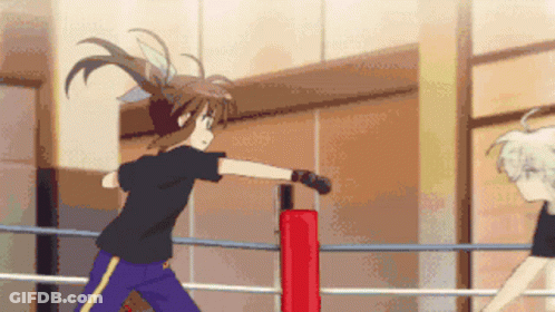 A Girl In A Black Shirt And Blue Pants Is Standing In A Boxing Ring GIF