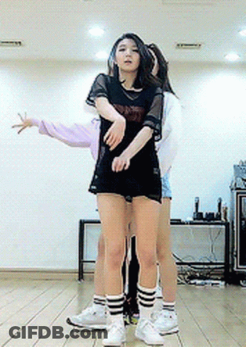 A Girl In A Black Shirt That Says ' Nct ' On It Is Hugging Another Girl GIF