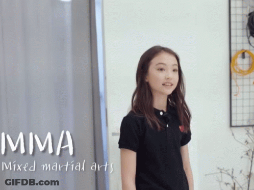 A Girl In A Black Shirt With Mma Mixed Martial Arts Written Above Her GIF