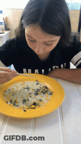 A Girl In A Black Shirt With The Word Malibu On It GIF