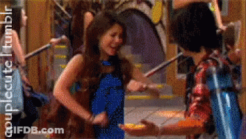 A Girl In A Blue Dress Is Dancing With A Boy In A Red Plaid Shirt GIF