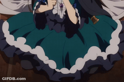 A Girl In A Blue Dress Is Holding A Necklace GIF