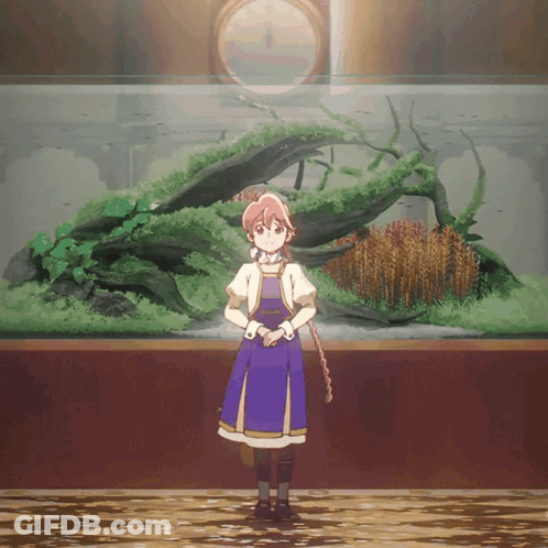 A Girl In A Blue Dress Is Standing In Front Of A Large Fish Tank GIF