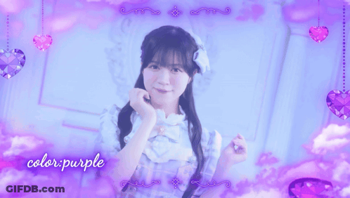 A Girl In A Blue Dress Stands In Front Of A Purple Background With The Words Color Purple Written On It GIF