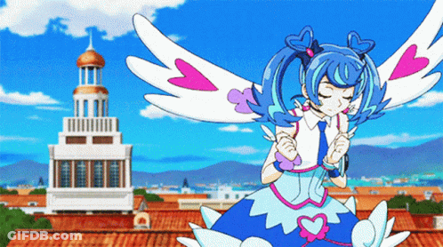 A Girl In A Blue Dress With Wings Is Standing In Front Of A Tower GIF