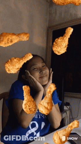 A Girl In A Blue Shirt With The Number 8 On It Is Surrounded By Fried Chicken GIF