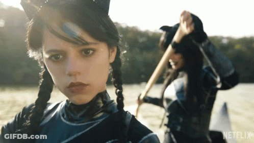 A Girl In A Cat Costume Is Standing Next To Another Girl In A Netflix Advertisement GIF