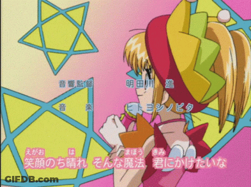 A Girl In A Colorful Costume Is Standing In Front Of A Star GIF