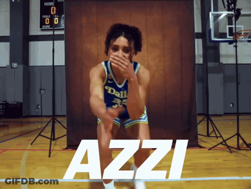 A Girl In A Dallas Jersey Is Kneeling On A Basketball Court GIF