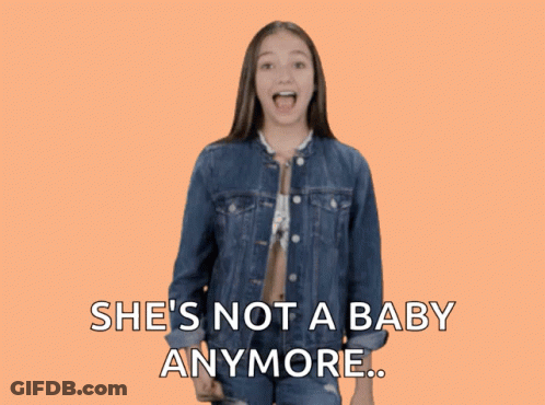 A Girl In A Denim Jacket Giving A Thumbs Down Sign With The Words She 'S Not A Baby Anymore GIF