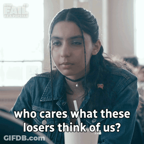 A Girl In A Denim Jacket Is Saying Who Cares What These Losers Think Of Us GIF