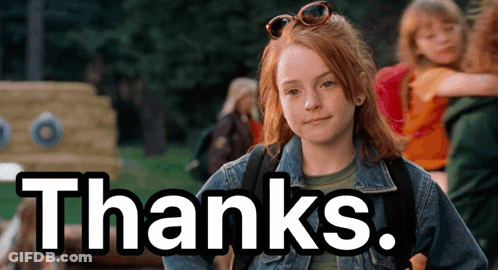 A Girl In A Denim Jacket Is Standing In Front Of A Sign That Says " Thanks " GIF