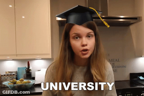 A Girl In A Graduation Cap Says University In A Kitchen GIF