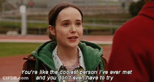 A Girl In A Green Jacket Is Talking To A Man In A Red Jacket . GIF