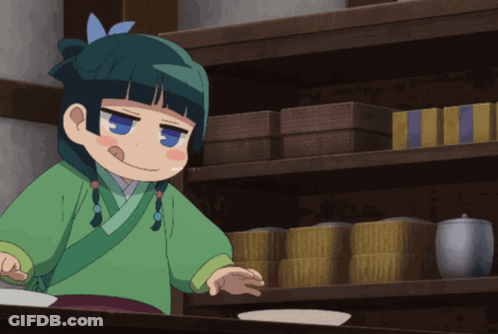 Girl In Green Kimono In Front Of Shelf Of Boxes GIF