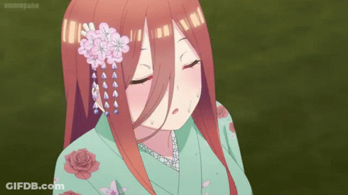 A Girl In A Green Kimono With Flowers In Her Hair GIF