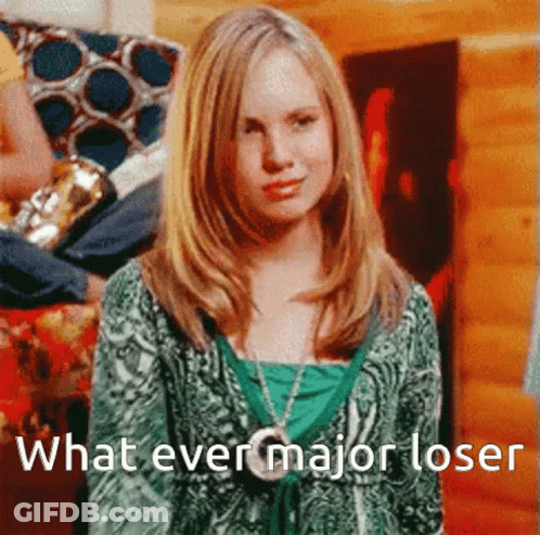 A Girl In A Green Shirt Is Standing In Front Of A Sign That Says What Ever Major Loser GIF