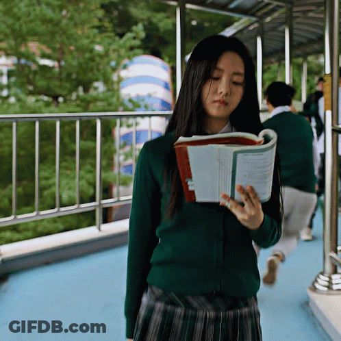 A Girl In A Green Sweater Reads A Book GIF
