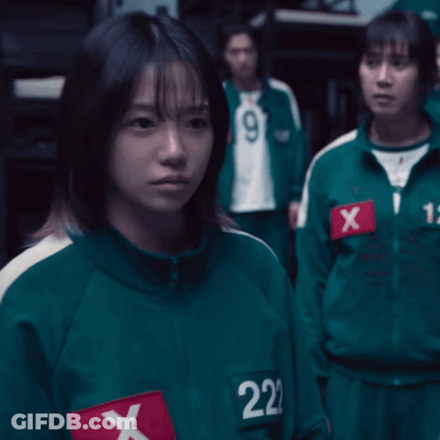A Girl In A Green Uniform With The Number 222 On Her Chest GIF
