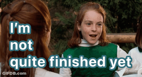 A Girl In A Green Vest With The Words I 'M Not Quite Finished Yet Above Her GIF