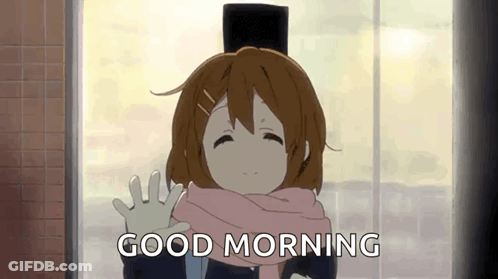 A Girl In A Hat And Scarf Is Waving At The Camera . GIF