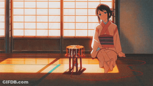 A Girl In A Kimono Sits On The Floor With A Drum In Front Of Her GIF