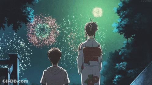Girl In Kimono And Boy In Front Of Fireworks GIF