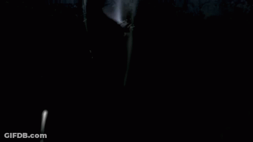 A Girl In A Maid Dress Is Standing In Front Of A Group Of People GIF