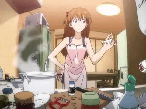 Girl In Pink Apron Standing In Kitchen GIF