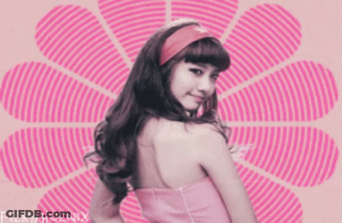 A Girl In A Pink Dress Is Standing In Front Of A Pink Flower With Fieryphoenix Written On The Bottom GIF
