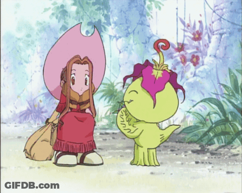 A Girl In A Pink Hat Is Sitting Next To A Green Monster GIF